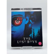 The Lost Boys Limited Edition UK Steelbook 4K Ultra HD and Blu-Ray cover with vampire-themed artwork and reflective sunglasses design