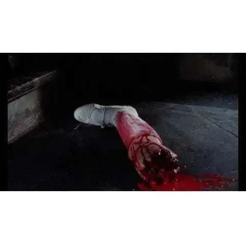 Bloodied severed arm in a horror scene from "Rabid Grannies" film on Blu-Ray.