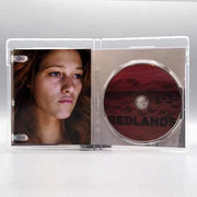 Open Redlands Blu-Ray case showing disc with red desert design and close-up portrait of a young woman inside cover