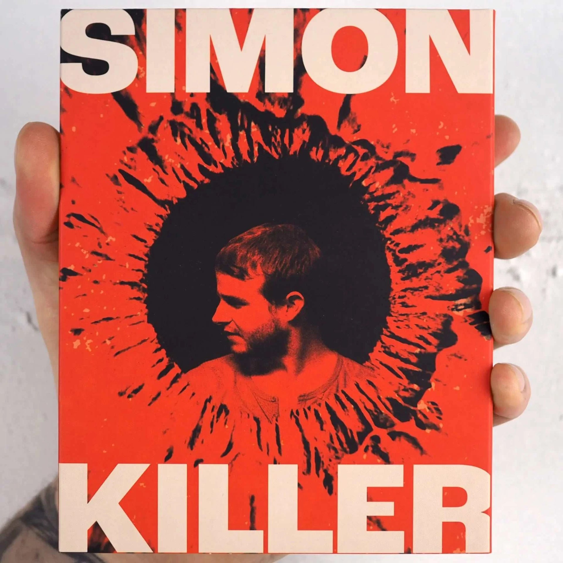 IFC Films Simon Killer Blu-Ray with slipcover featuring bold design and film title.