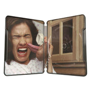 A Nightmare On Elm Street 4K Ultra HD and Blu-Ray limited edition Steelbook interior showing iconic horror scene with woman screaming and Freddy Krueger's tongue and clawed hand