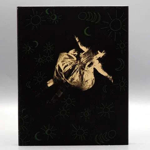 Shudder All the Moons Blu-Ray with limited edition slipcover featuring dark artistic design of a girl surrounded by moon phases and suns.