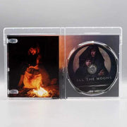 Shudder All the Moons Blu-Ray open case showing disc and cover art with a person by fire and two figures on the disc.