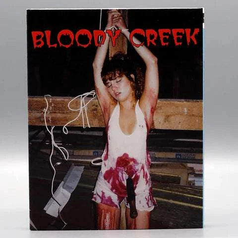 Bloody Creek Blu-Ray slipcover featuring blood-stained woman tied up in horror scene