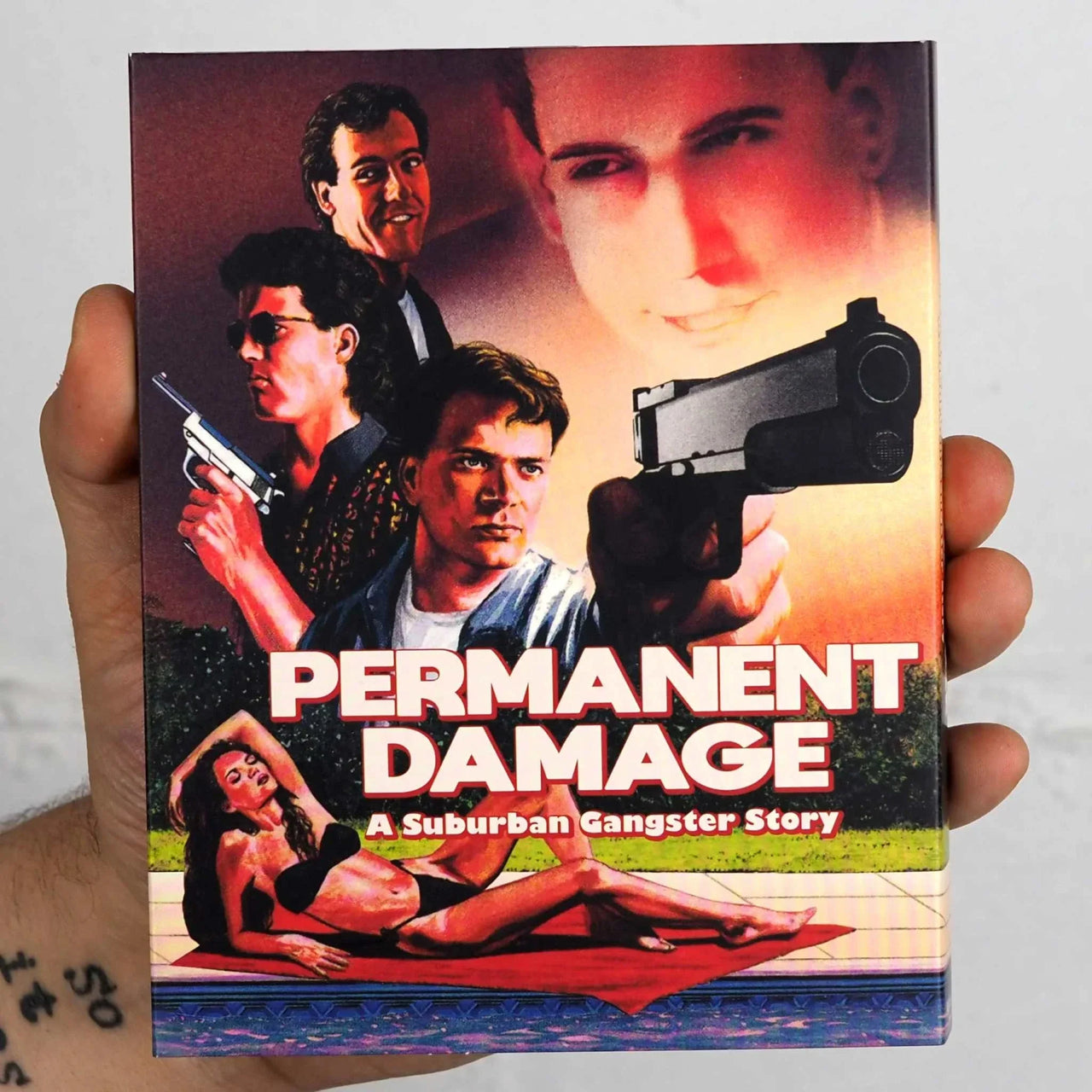 VHSHitfest Permanent Damage Blu-Ray slipcover featuring a suburban gangster story cover art with characters and a gun