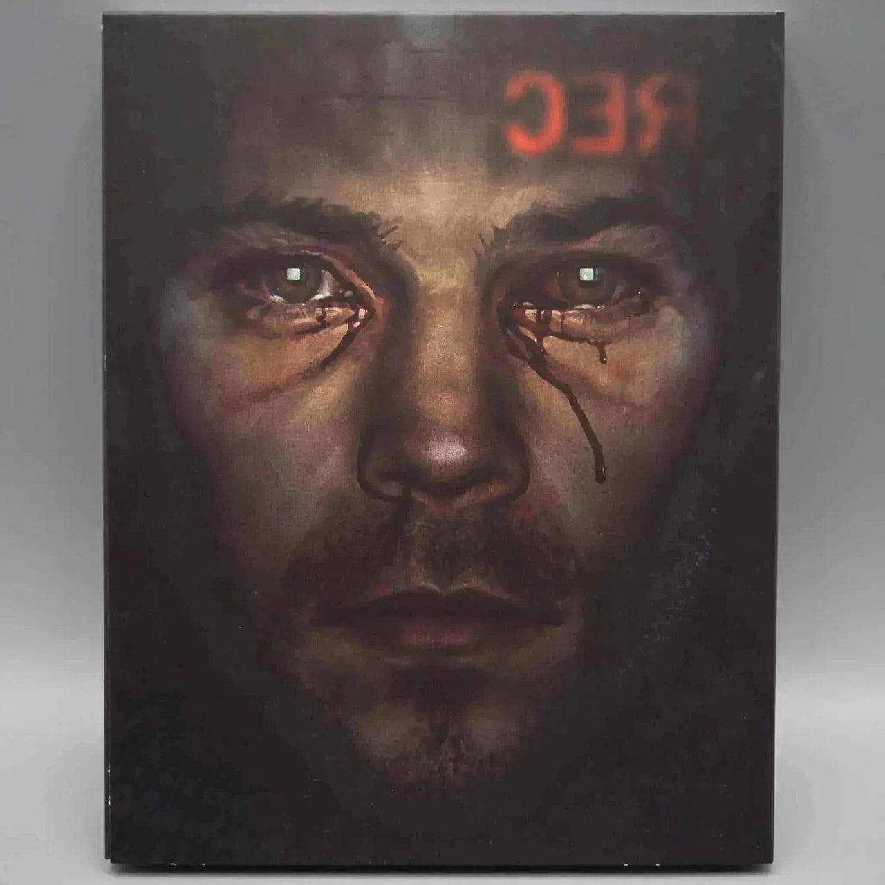 Dark Star Feardotcom Blu-Ray slipcover featuring a close-up of a man's tear-streaked face with a red REC symbol reflection on forehead.