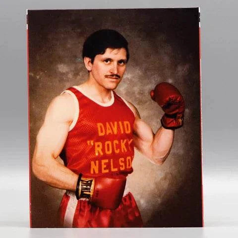 David "The Rock" Nelson posing in a red boxing outfit with gloves, featured on the Saturn's Core Blu-Ray cover.