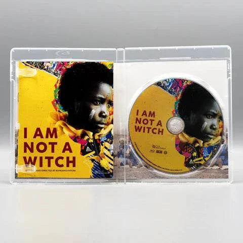 Film Movement I Am Not a Witch Blu-Ray open case showing cover art and disc with image of a girl in colorful traditional attire and bold text I Am Not a Witch.
