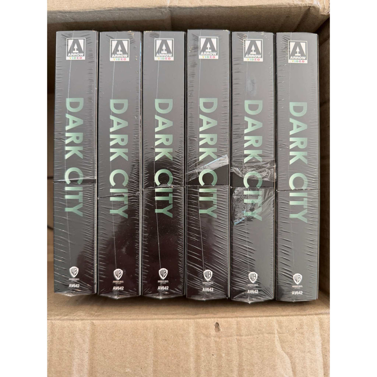 Box of six sealed Dark City Limited Edition 4K UHD steelbook slipcases with damaged inner spines