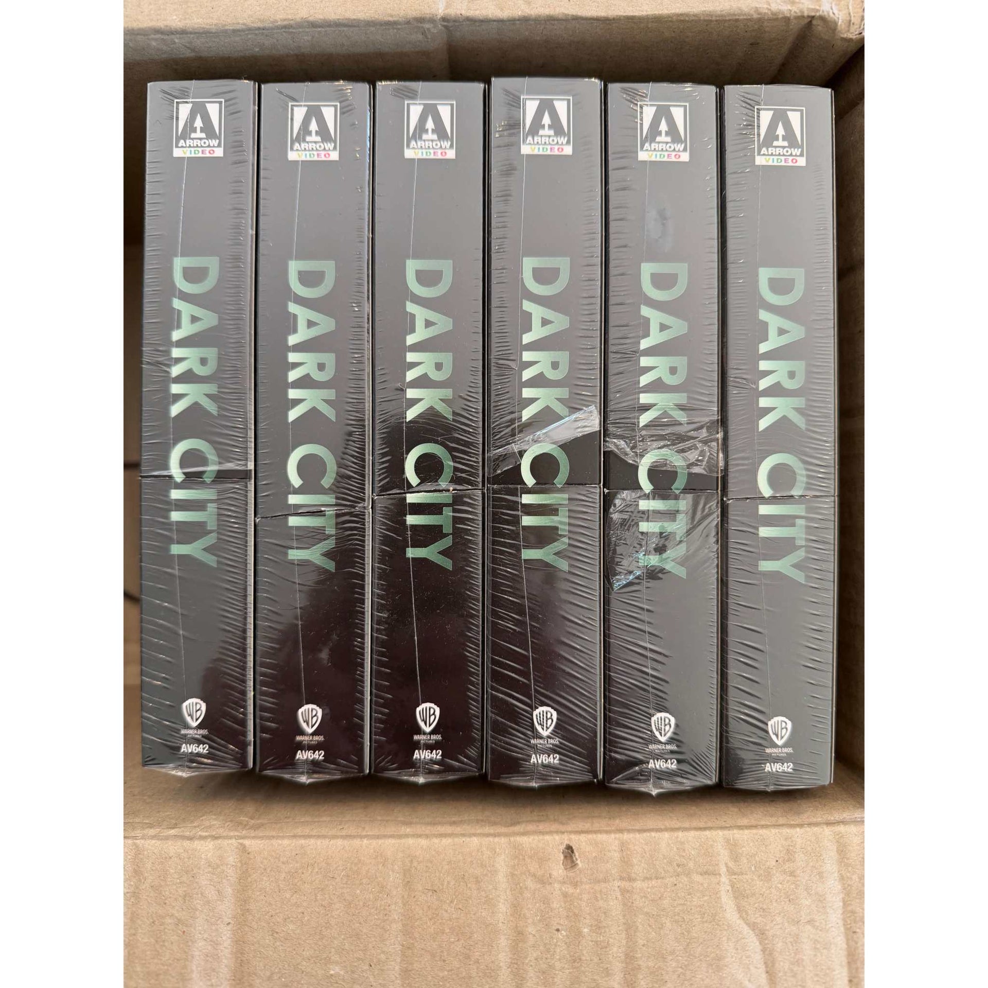 Box of six sealed Dark City Limited Edition 4K UHD steelbook slipcases with damaged inner spines