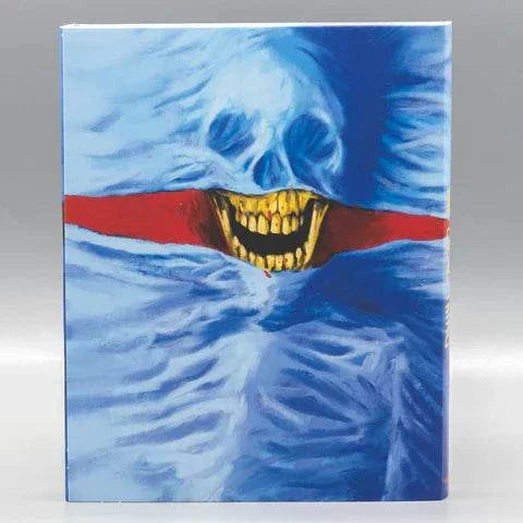 The Dead Thing Blu-Ray with limited edition slipcover featuring horror artwork of a grinning skull on a blue and red background