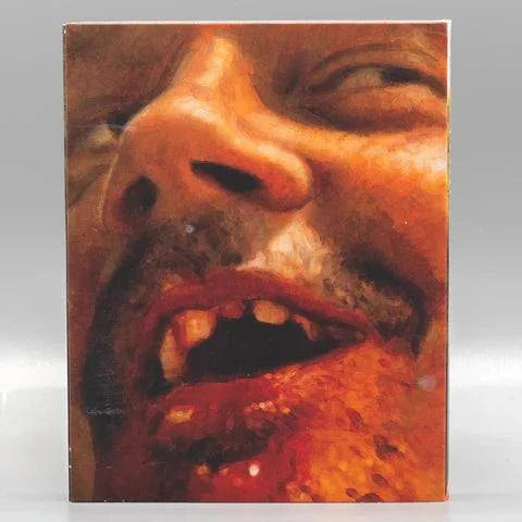 Trigger Man Blu-Ray with limited edition slipcover showing close-up of a man's bloody face and missing teeth.