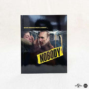 Nobody 4K UHD limited edition full slip and steelbook with exclusive booklet and poster on white background
