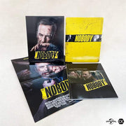 Nobody 4K UHD limited edition steelbook with full slip cover, poster, and booklet displayed on a white background